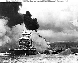 USS Maryland burning and USS Oklahoma Capsized.