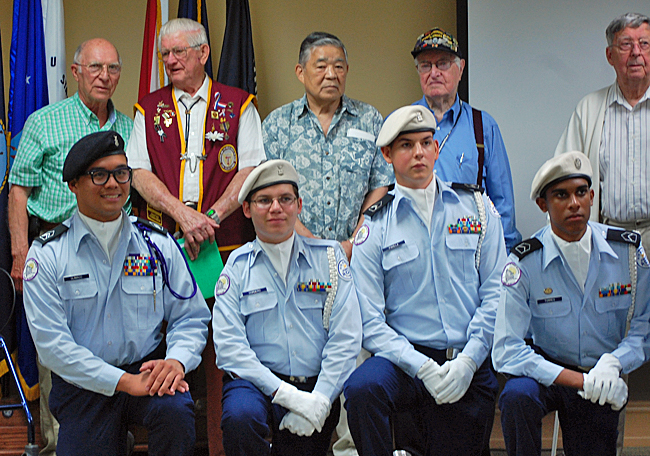 Some of the former POW's pose with members of the Timber Creek Air Force Junior ROTC Honor Guard.