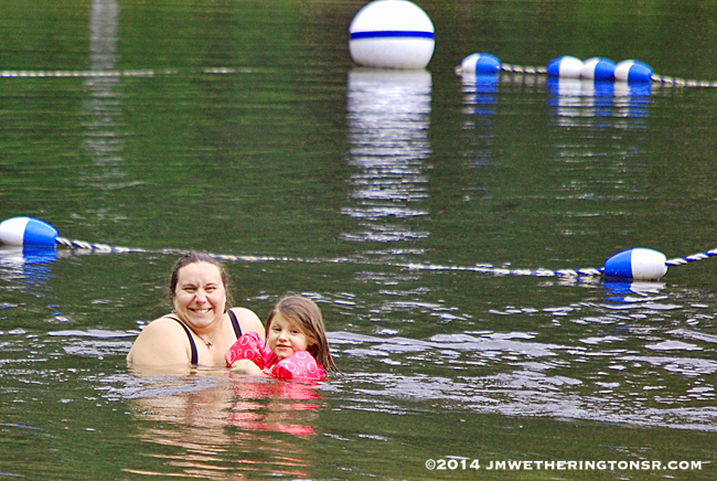Amber and Abby in the cold mountain lake water.