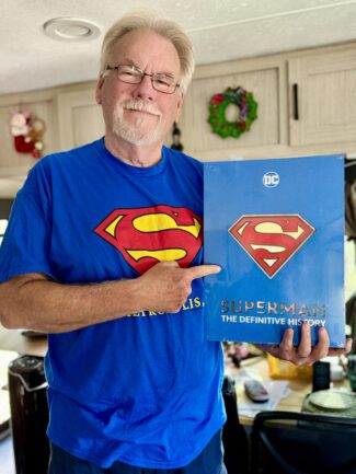 Jeff holding his copy of Superman: The Definitive History by Edward Gross and Robert Greenberger.